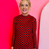 Red and black checkered long sleeve mesh top for bold, lightweight layering.