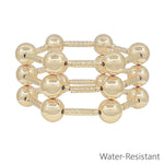 Water resistant gold tube and 14mm beaded bracelet set stacked together in a polished gold finish