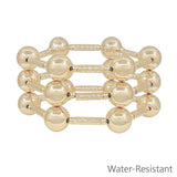Water resistant gold tube and 14mm beaded bracelet set stacked together in a polished gold finish