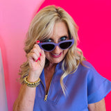 Model playfully posing with Dime Last Call Lavender Fog Polarized Sunglasses pulled slightly down, showcasing the sleek cat-eye shape and soft lavender frame.