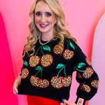 Black leopard cherry sweatshirt with sequin stem accents and relaxed cropped fit.