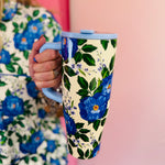 40 oz tumbler with blue floral print, handle, and flip straw lid.