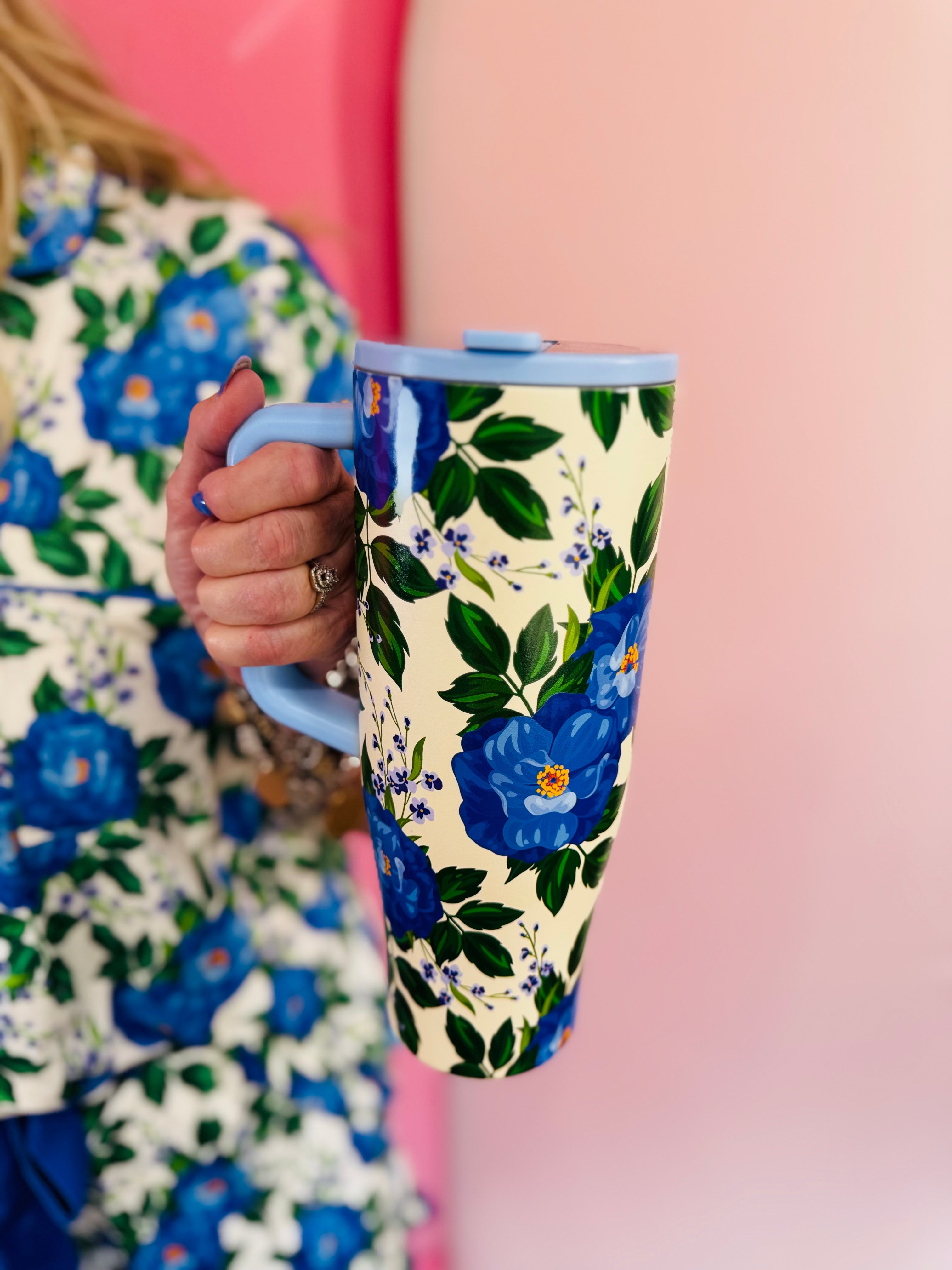 40 oz tumbler with blue floral print, handle, and flip straw lid.