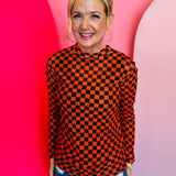 Orange and black checkered long sleeve mesh top for bold, breathable layering.
