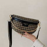 Handbag with houndstooth pattern and gold chain strap.