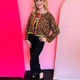 Leopard print rhinestone sweater with rainbow trim and adjustable front ties.