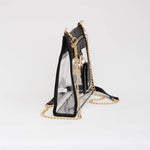 Clear crossbody bag with black trim and gold hardware, featuring a detachable sunglasses holder—fun and functional for any event.