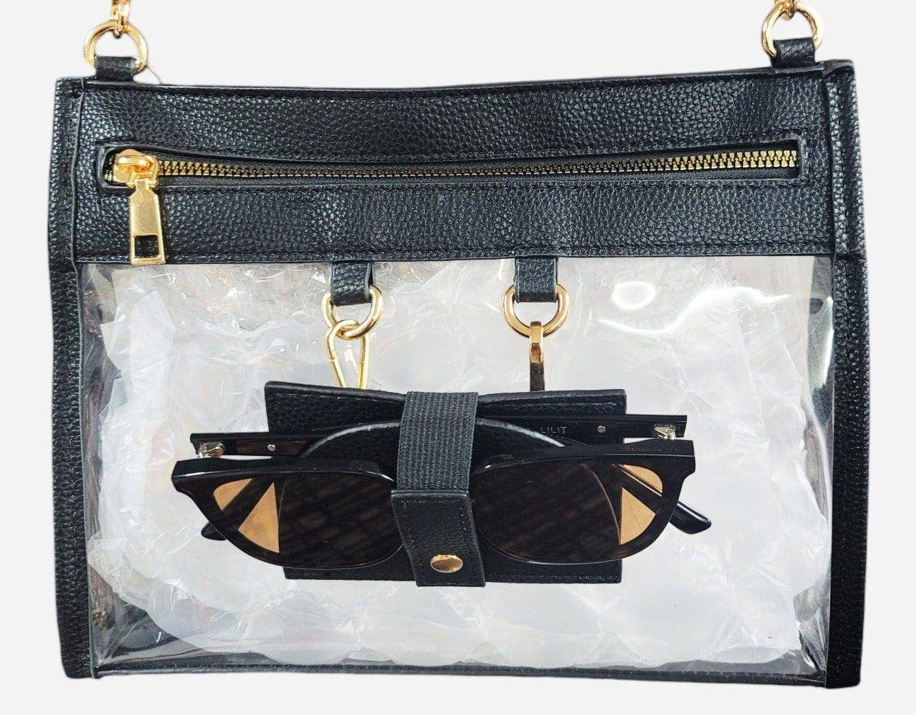 Clear crossbody bag with black trim and gold hardware, featuring a detachable sunglasses holder—fun and functional for any event.