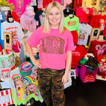 Bright pink tee with oversized AMEN letters filled with leopard, star, camo, and checkered patterns.