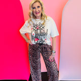 Western graphic tee with checkerboard background, wild card slogan, leopard accents, and rhinestone details.