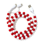 A vibrant red and white beaded phone charger cable.