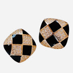 Black and white checkered enamel stud earrings with rhinestone accents.