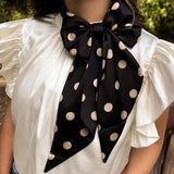 Black and gold silky polka dot scarf with versatile styling options.