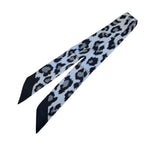 Black and grey leopard print silky scarf tie used as a twilly or purse strap.