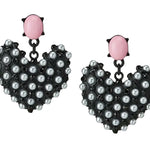 Pastel pink oval stud earrings with black enamel heart dangle and pearl accent.