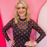 Black mesh top with orange polka dots and mock neckline.