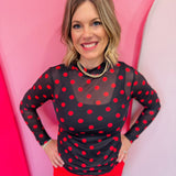 Black mesh long sleeve top with bold red polka dots and mock neckline.