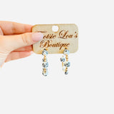 Water-resistant Chinoiserie hoop earrings with black, white, and gold beads.