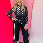 Black mesh top with white polka dots and mock neckline.2