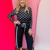 Black mesh top with white polka dots and mock neckline.2