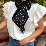 Black and white silky polka dot scarf with versatile styling options.