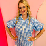 Blue gingham puff sleeve top with zip front and striped collar trim.