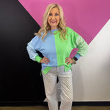 Blue and green colorblock sweatshirt with gingham sleeves and high-low hem.
