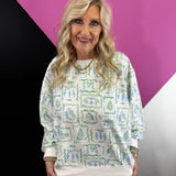 White Christmas sweatshirt with vintage blue and green toile Santa, nutcracker, tree, and present print.