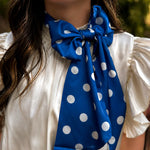 Blue and white silky polka dot scarf with versatile styling options.