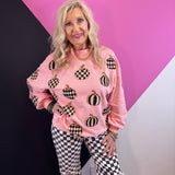 Pink pumpkin pullover with black and white checkered and striped pumpkins and sequin accents.