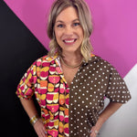 Brown mixed print cotton top with retro florals, polka dots, collar, and puff sleeves.