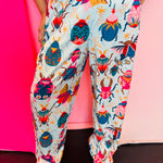 Aqua pants with colorful bug, butterfly, and beetle print design.
