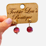 Water-resistant burgundy marbled drop earrings with gold posts and 1.25-inch drop length.