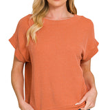 Burnt orange raised rib knit top with cap sleeves and boat neckline.