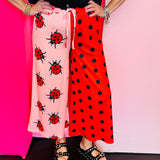 Half pink ladybug and half red polka dot cropped pants with elastic waistband.
