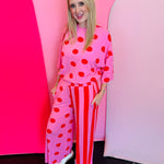 Pink ribbed set with red polka dots and mixed stripe wide-leg pants.