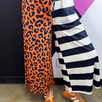 Cropped wide-leg pants with orange leopard print and black and white stripes.