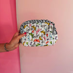 Quilted butterfly print bag with leopard ruffle trim and zipper closure.