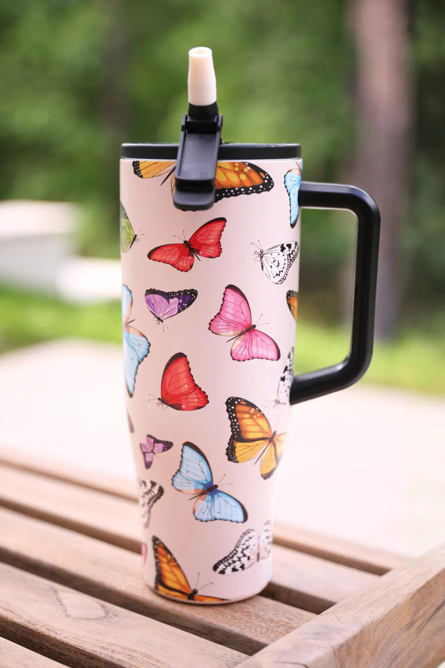 40oz butterfly print tumbler with flip straw lid and handle.