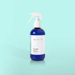 Volcano linen spray bottle with tropical citrus fragrance for refreshing fabrics.