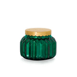An 8oz Capri Blue Volcano Royal Gem Petite Candle in a decorative green jar.