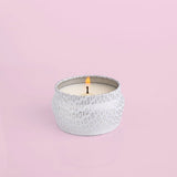 Capri Blue Volcano Mini White Tin Candle with tropical fruits and sugared citrus fragrance.