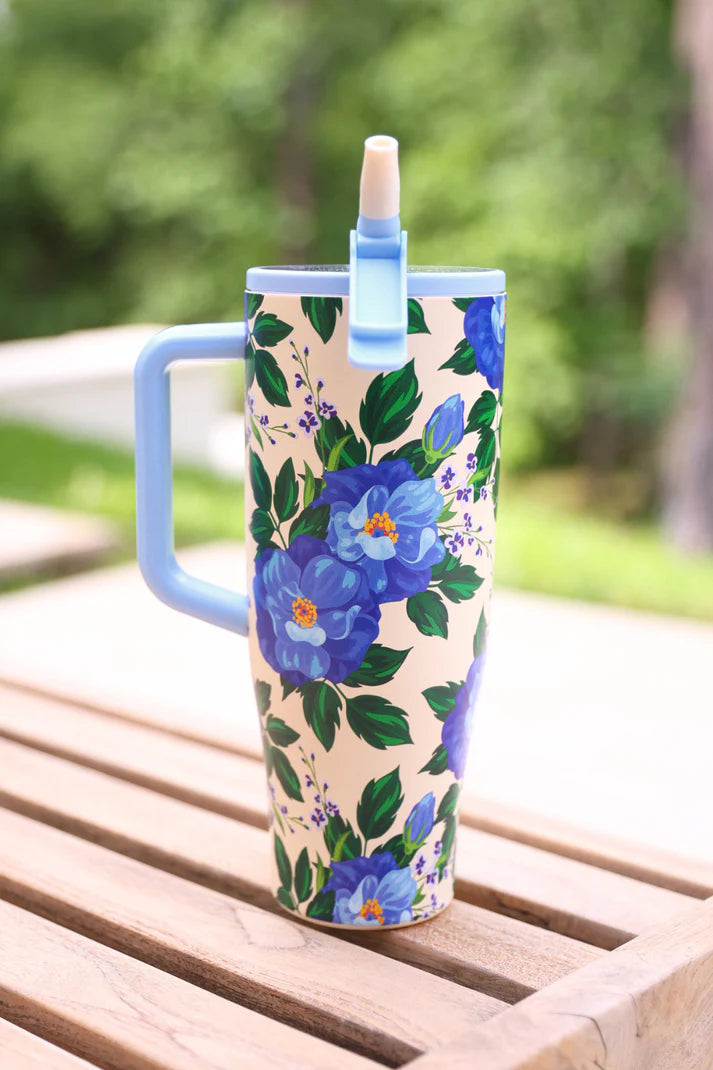 40 oz tumbler with blue floral print, handle, and flip straw lid.