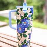 40 oz tumbler with blue floral print, handle, and flip straw lid.