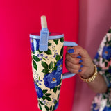 40 oz tumbler with blue floral print, handle, and flip straw lid.