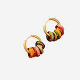 Petite gold hoop earrings with colorful dangling discs, lightweight and vibrant accessory.