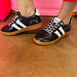 Black metallic Corky's sneakers with white side stripes and lace-up closure.