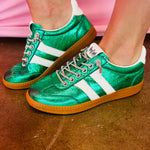 Green metallic Corky's sneakers with white side stripes and lace-up closure.