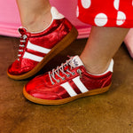 Metallic red Corky's sneakers with white side stripes and lace-up closure.