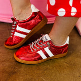 Metallic red Corky's sneakers with white side stripes and lace-up closure.